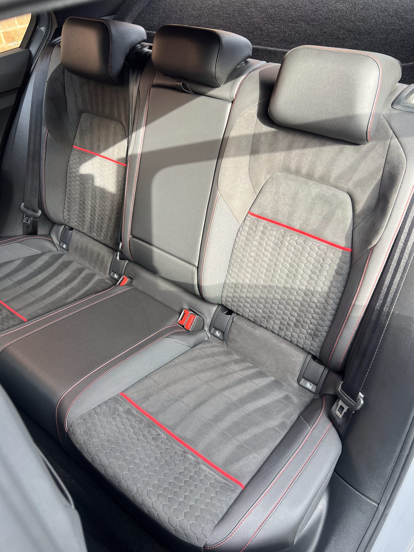 Freshly detailed black leather car interior — gleaming dash and seats
